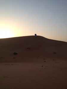 Car on top of mountain that is actually a sand dune.